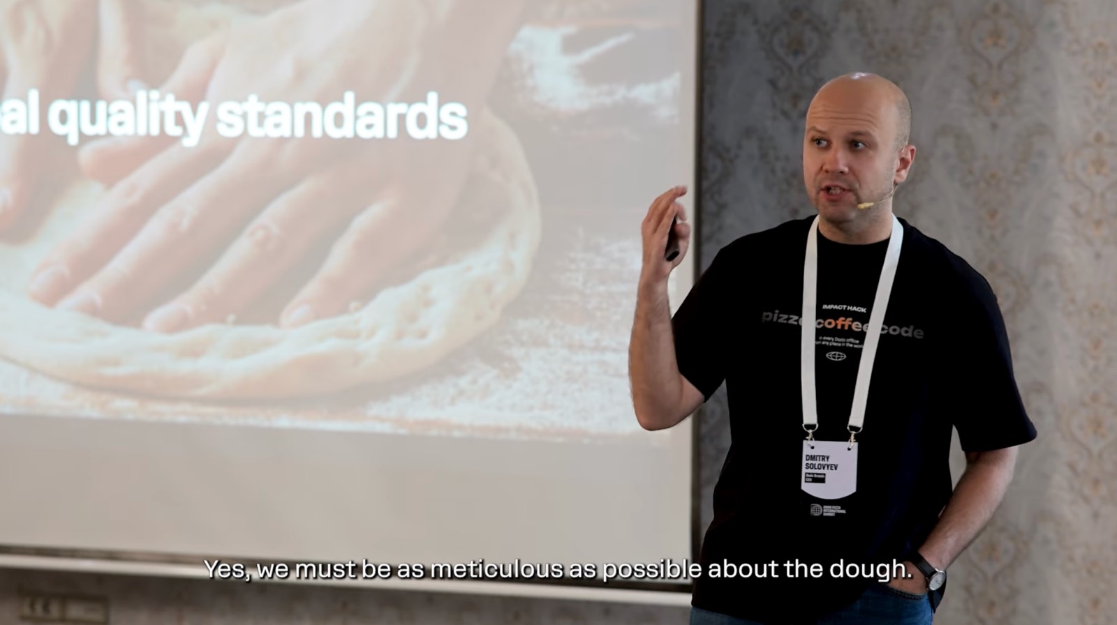 Speaker at the summit presenting a slide about quality standards for the dough
