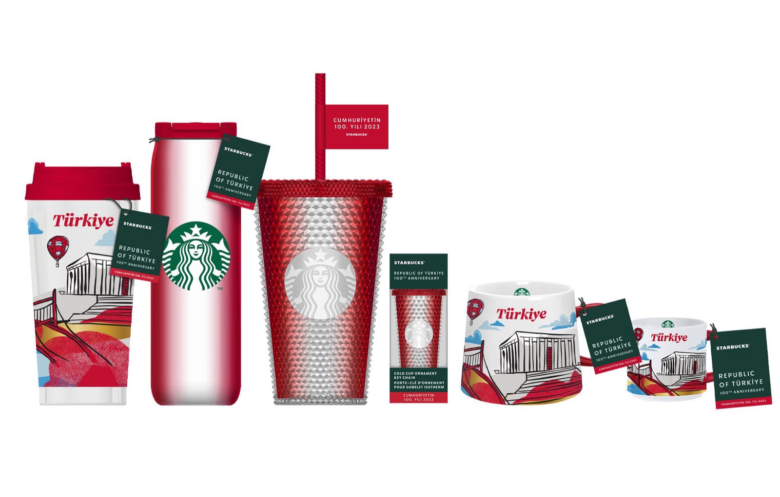 The Türkiye 100th anniversary collection on white: a hot cup, a tumbler, a studded cold cup, a mug and ornaments, all in red with Istanbul landmark drawings